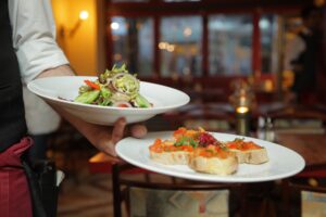 Person Holding Pastry Dishes on White Ceramic Plates